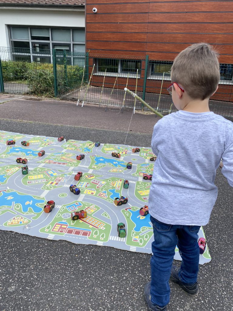 enfant jouant a attraper des voitures